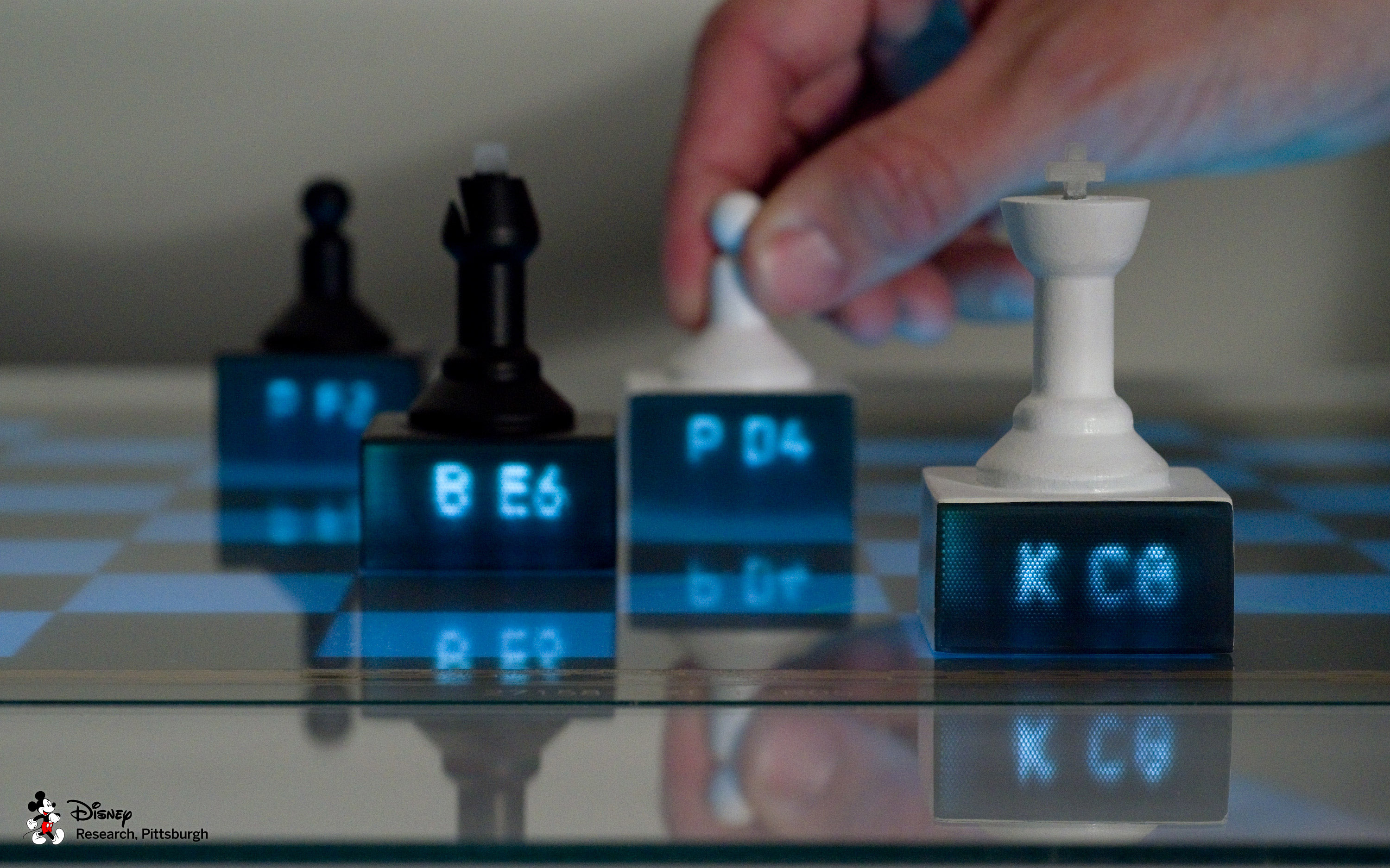 Chess pieces with embedded light pipes display content piped from an interactive tabletop. Contextual information, such as chess piece location and suggested moves, can be displayed on each individual piece.